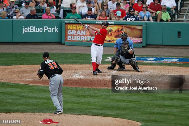 David Murphy of the Boston Red Sox hits the ball against the Miami Marlins in the fifth inning during a spring training game at JetBlue Park on March...