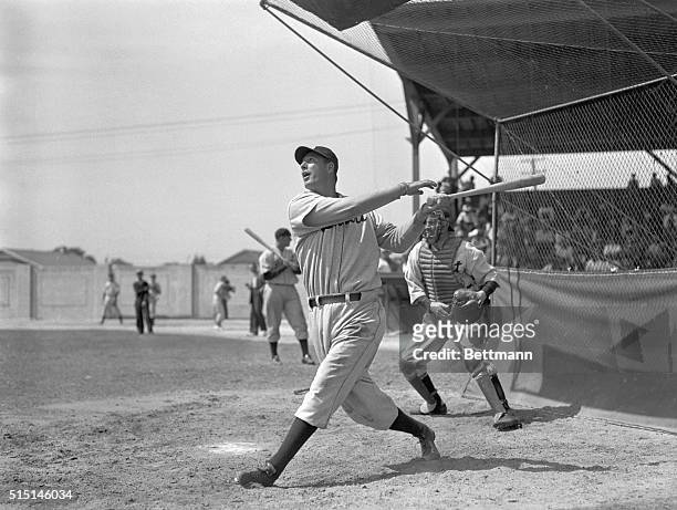 Henry Greenberg, the regular first baseman is shown batting, with Ray Hayworth catching, during a practice session at the spring training camp of the...