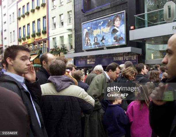 People queue up outside the Odeon cinema in Leicester Square for the first public showing of the Harry Potter movie in London's west end, 16 November...