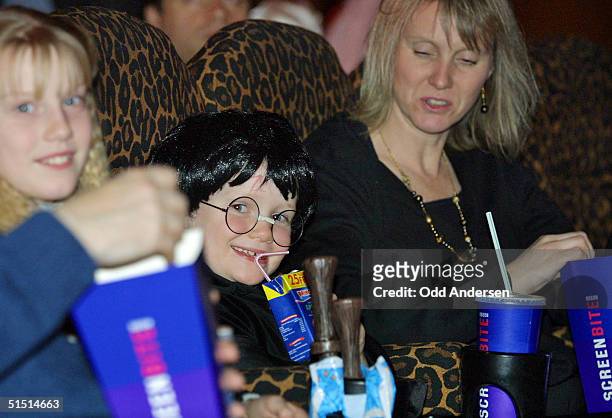 Harry Potter fans enjoy their popcorn as they are seated for the show the Odeon cinema at Leicester square in central London, 16 November 2001....