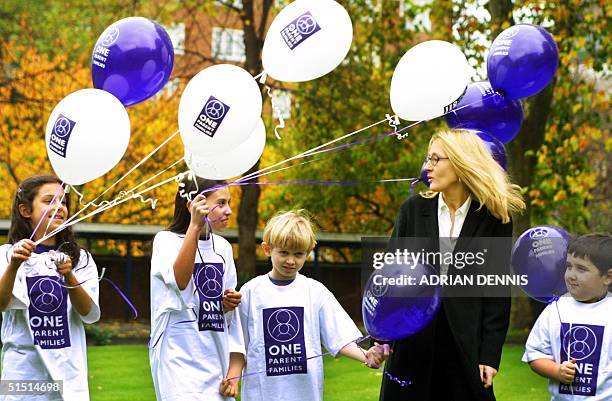 Joanne Kathleen Rowling , author of the Harry Potter books, and Ambassador for the National Council for One Parent Families, dodges the balloons held...