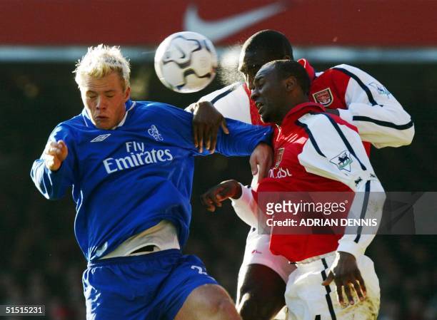 Arsenal's Sol Campbell and Patrick Vieira fight for the ball with Chelsea's Eidur Gudjohnsen to clear the ball from their penalty area during the...