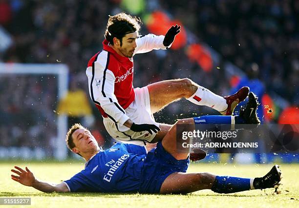 Chelsea's John Terry tackles Arsenal's French midfielder Robert Pires during the Premier League match at Highbury in London 26 December 2001. Arsenal...