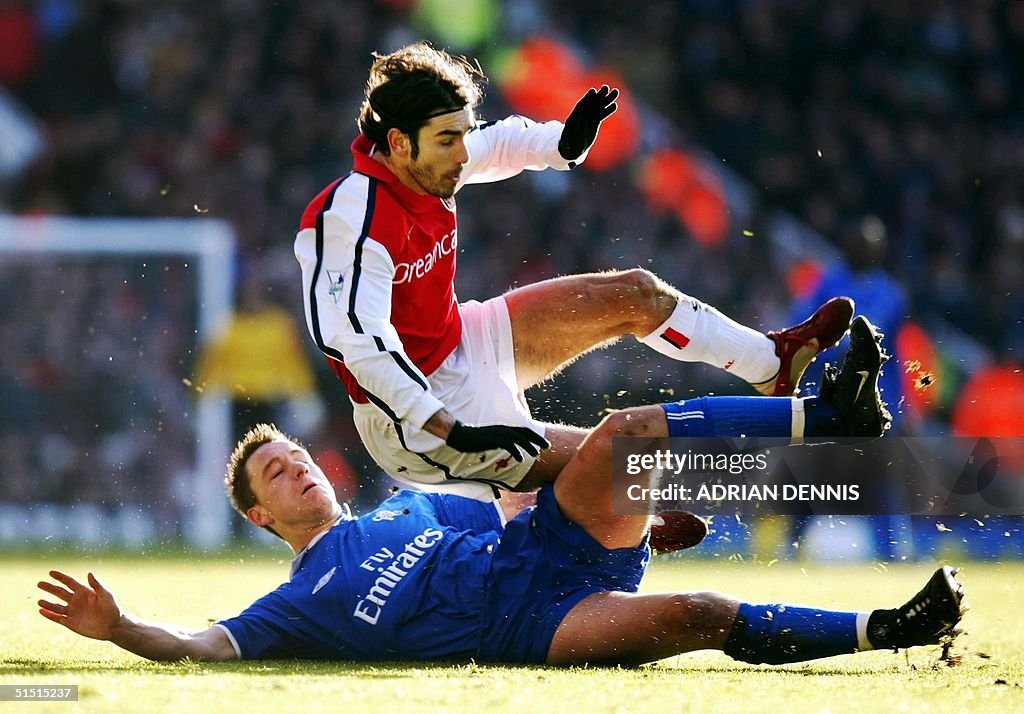 Chelsea's John Terry (bottom) tackles Arsenal's Fr