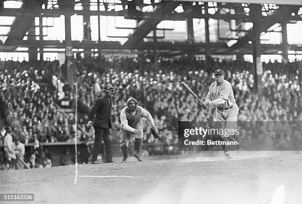 Babe Ruth finishing tremendous swing that netted him a single in exhibition Yankee-Dodger game a Ebbets Field. Babe got two other singles and proved...