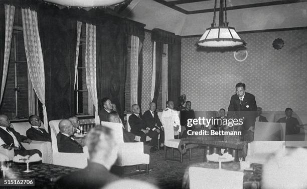 Premier Prince Fumimaro Konoye, President of the House of Peers, right, is shown here at table, as he discussed with the newly assembled Japanese...