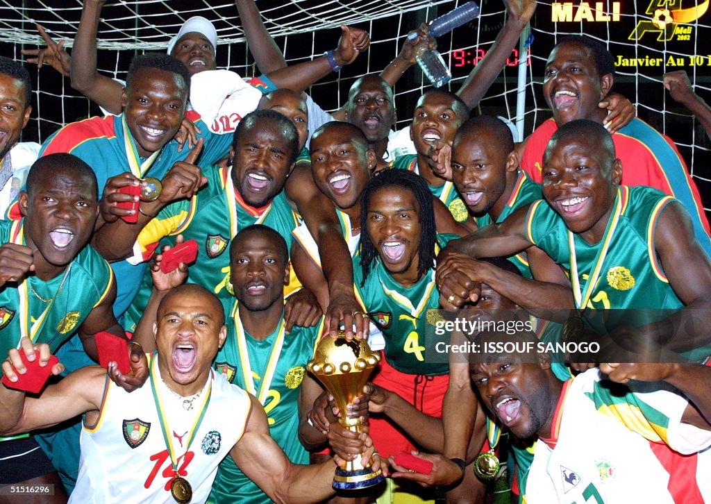 Cameroonian players jubilate with the cup after wi