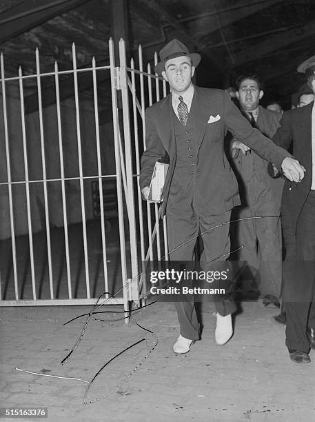 Johnny Vander Meer leaves Ebbets Field after pitching his second consecutive no-hits, no-runs game against the Brooklyn Dodgers at Ebbets Field.