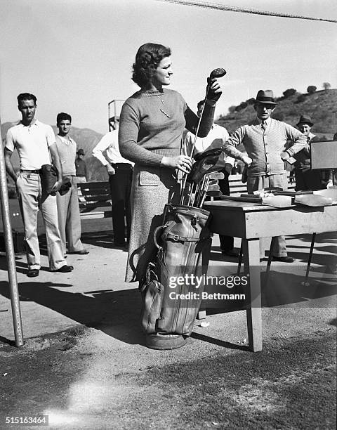 Babe Didrikson, outstanding woman athlete, with her caddy and an admirer, as she played her first round in the 13th annual Los Angeles Open Golf...