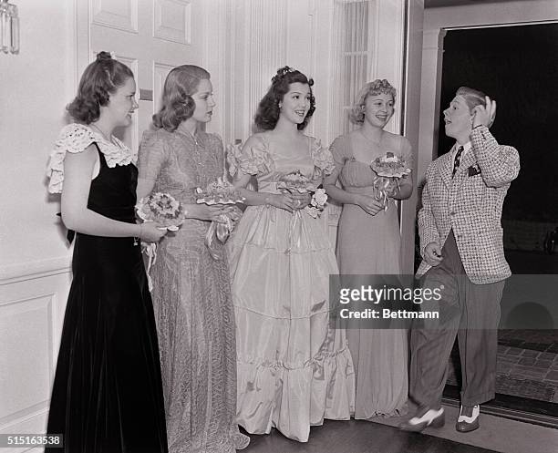 The youngest member of a Judge Hardy Family, is greeted here by four lovely girls as he joins Carey Wilson's party for the Metro Goldwyn Mayer family...