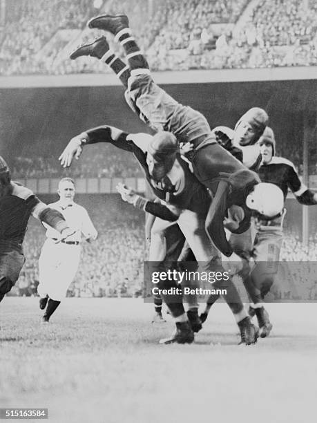 New York Giants' fullback Jack McBride is upended during a football game at the Polo Grounds in Harlem.