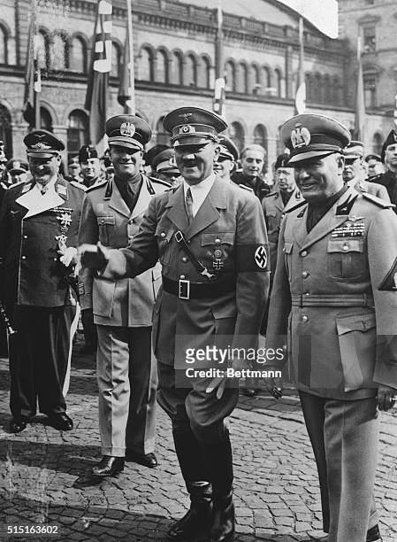 Munich, Germany:Reichfuehrer Adolf Hitler and Premier Benito Mussolini of Italy , on their arrival in Munich for four-power peace conference to iron...