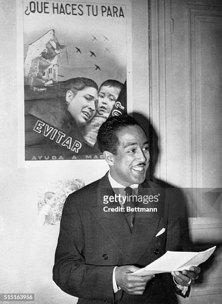 An eye witness of the battle of Teruel, still raging in Spain, Langston Hughes, American Negro poet, is pictured as he described conditions in the...
