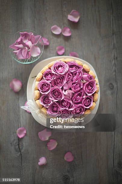 wedding or birthday cake with fresh lilac rose on wooden table up. closeup. - birthday cake from above stock pictures, royalty-free photos & images