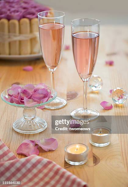 2 glasses of pink sparkling wine on wedding reception table top. - pink champagne stock pictures, royalty-free photos & images