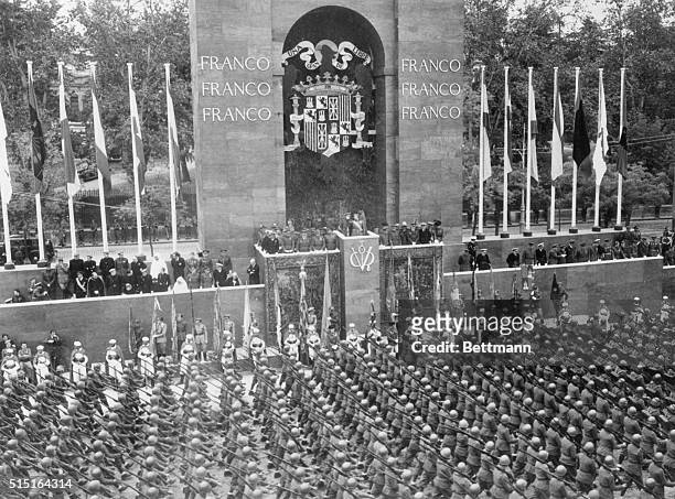 Madrid, Spain- General Francisco Franco is giving the salute to Italian troops passing in the recent huge victory parade in Madrid.