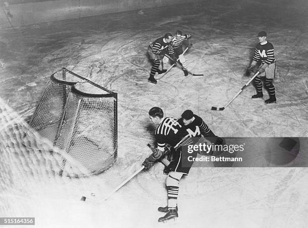 Johnny Gotteslig the Chicago Black Hawks as he tries to put the puck past goalie Walsh of the Montreal Maroons in the National Hockey League battle...