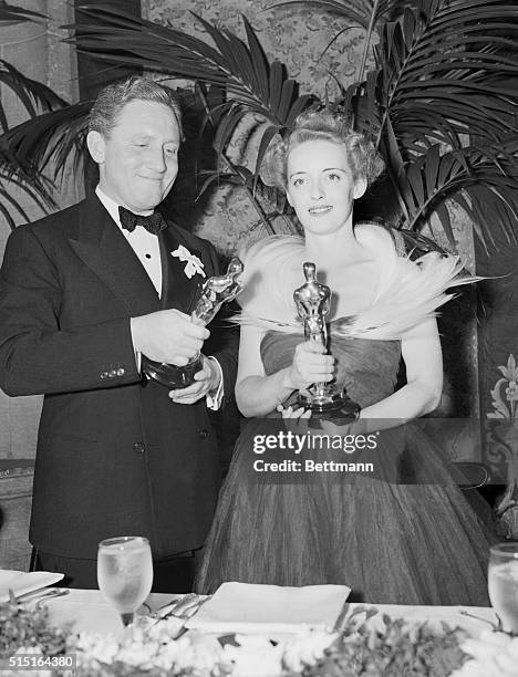 Hollywood, Calif.: Spencer Tracy and Bette Davis shown with their trophies for the Best Motion Picture of 1938 at recent Morton's Academy Awards...