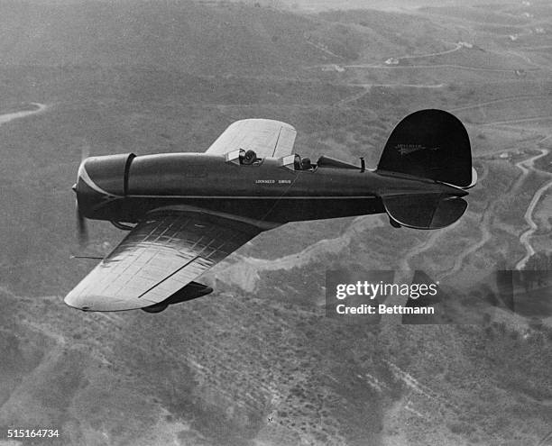 This striking aerial closeup of Lindy and Anne shows them above the hills of Hollywood trying out their new plane which was just recently delivered...