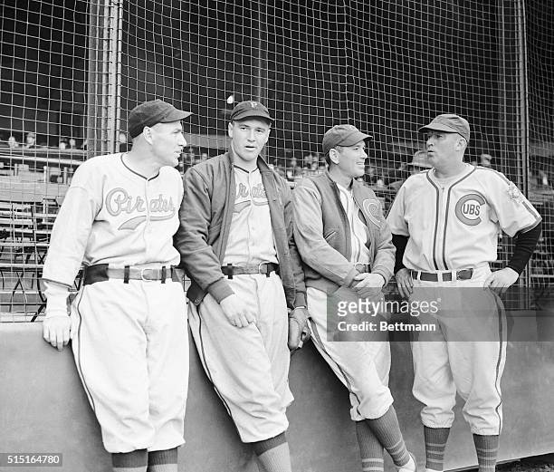 Talking things over before their exhibition game at Wrigley Field, March 18, are four eminent gentlemen of the Pittsburgh Pirates and Chicago Cubs...