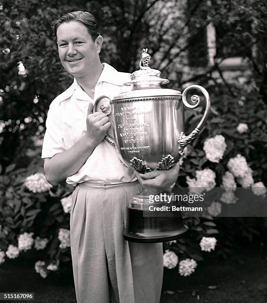 Byron Nelson, of Toledo, with the professional Golf Association's trophy, which he won when he defeated Sam Snead, of Shawnee-on-Delaware, one up.