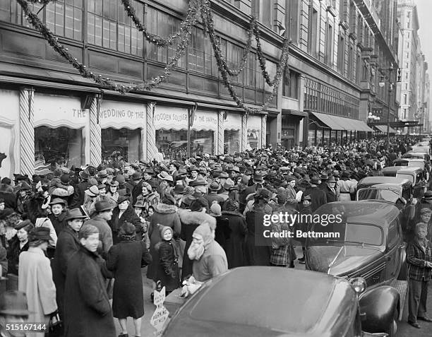 Christmas shoppers crowd outside the display windows of Macy's department store in Manhattan.