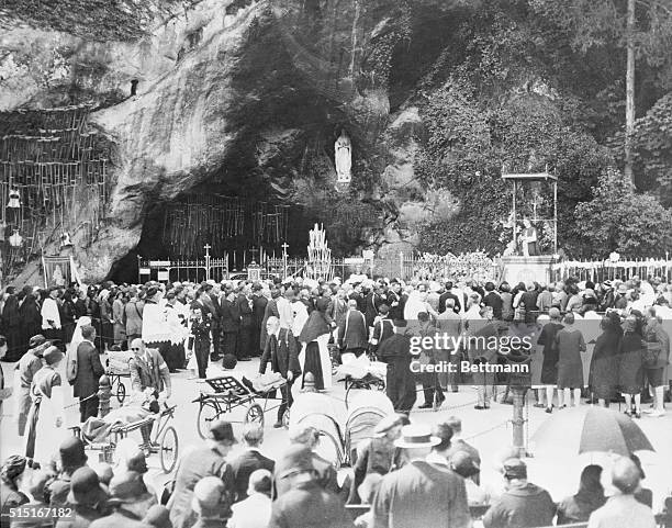 ....And the Lame Shall Walk. Lourdes, France: Touching scenes in the grotto of Our Lady of Lourdes, as hundreds of pilgrims stand before the...