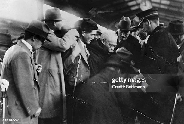 Photo shows Premier Hamaguchi of Japan being supported by colleagues just after a would-be assassin's bullets had pierced his stomach and left him...