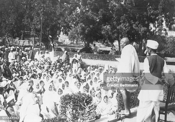 Mahatma Gandhi addressing some of his thousands of followers on the lawn of the home of Dr. Ansari where Gandhi stopped during his peace meetings...