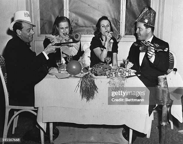 New York, NY- Giving an enthusiastic welcome to the New Year at the Club Versailles are, left to right, comedian Joe E. Lewis; Lois Elliman, social...
