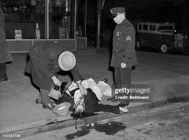 Murder victim David Beadle also known as David the Beetle in front of Spot Beer Tavern in Manhattan with a policeman and crime photographer Weegee.