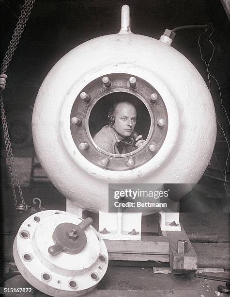 Otis Barton, inventor of the Barton tank, is shown here in the tank. The tank is to be used by William Beebe in his deep sea exploration expedition...