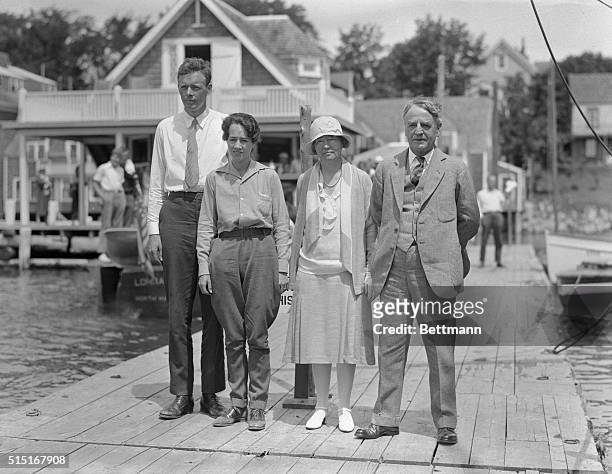 Left to right, Colonel Charles A. Lindbergh, his wife, Anne Lindbergh, and her parents, Mrs. And Senator Dwight W. Morrow on the pier as the Morrows...