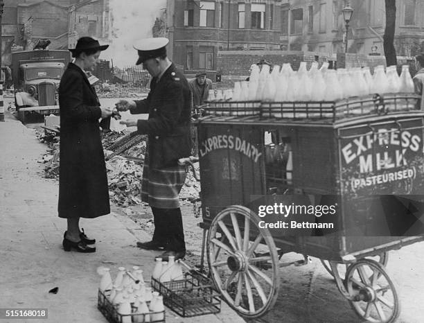 "The Man Who Comes Around." London, England: A heavy blitz upon the city on the preceding evening means little to his milkman who is around with his...