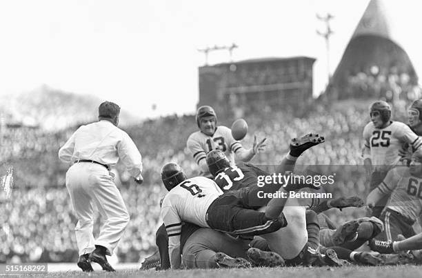 Joe Stydahar , Chicago Bears lineman, gathers in a fumbled ball, dropped by Sammy Baugh of the Washington Redskins. The Bears' power snowed under the...