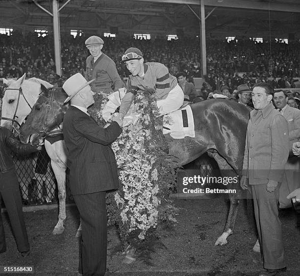 Here's a combination that is proving very hard to beat these days in horse racing circles. Trainer Ben Jones is congratulating jockey Eddie Arcaro,...