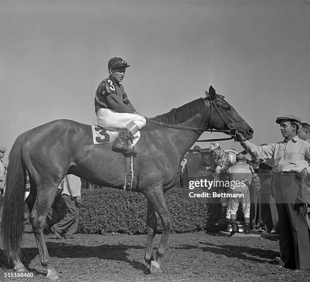 Whirlaway, with jockey W. Eads up, stands in the winner's circle after winning the Henry of Navarre feature race at Belmont today. Backed down to...
