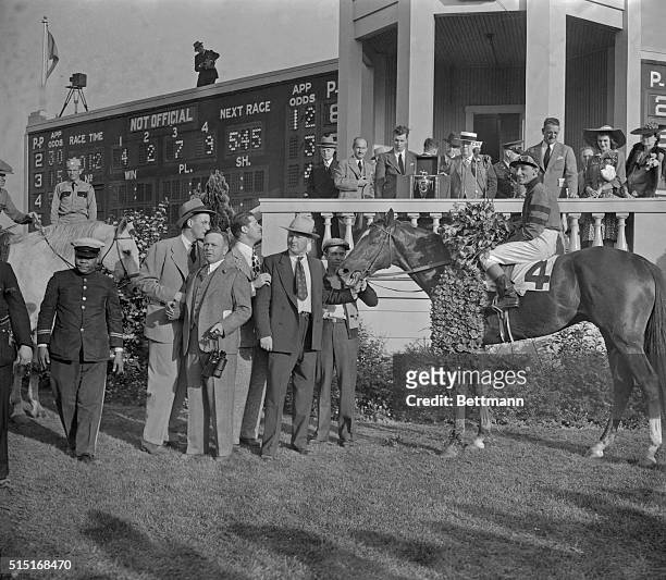Jockey Eddie Arcaro in the winner's circle at the Kentucky Derby. They would go on to win the Triple Crown.