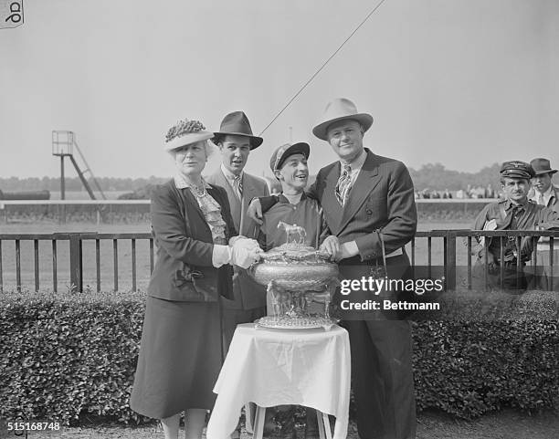 The presentation of the trophy after Calumet Farm's Whirlaway won the $25,000 added Belmont Stakes, adding that victory to the Kentucky Derby and...