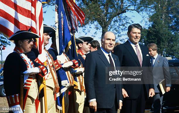 President Reagan and French President Francois Mitterrand pause revolutionary guard at Yorktown, Va.