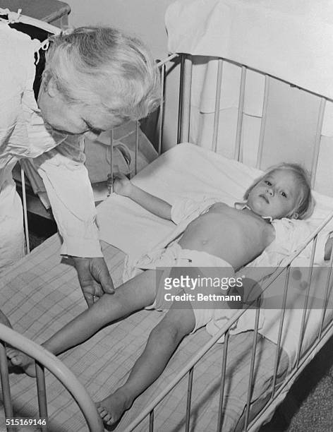 Sister Elizabeth Kenny, introducer of the hot pack method of treating infantile paralysis, works on a young polio victim in the Kenny Infantile...