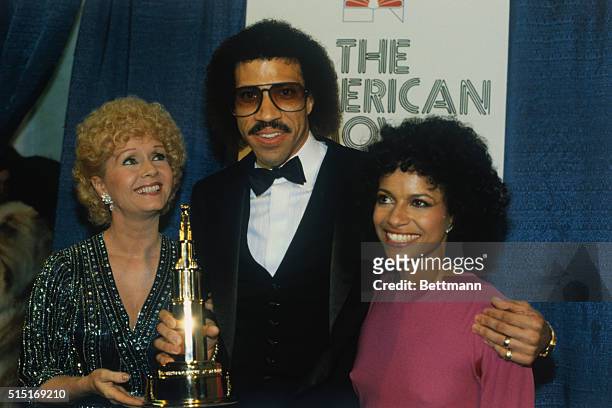 Hollywood: Actress Debbie Reynolds and Debbie Allen congratulate Lionel Ritchie for winning his American Film Awards trophy for the Best Original...