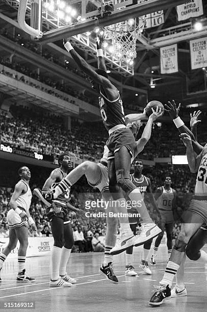 Celtics' Larry Bird crashes into Houston Rockets' Ralph Sampson as he goes up for an off balance shot during 1st quarter action of game one of the...