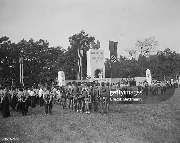 Just like a scene from Germany is this one, as several hundred German Americans snap into the Nazi salute against a background not unlike that one...