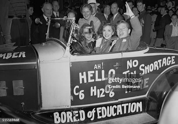 Discarding the usual chauffeur and limousine for a movie premiere, Judy Garland, Ann Rutherford and Mickey Rooney arrive for the premiere of MGM's...