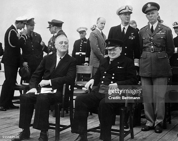 President Roosevelt and Prime Minister Churchill are shown as they sat on the big forward deck of H.M.S. Prince of Wales to relax, chat and breathe a...