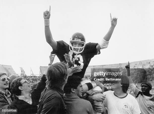 Football fans give jubilant Mississippi State quarterback John Bond a ride after State upset top ranked Alabama.