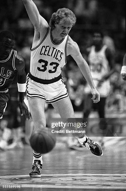 Bulls' Michael Jordan and Celtics' Larry Bird chase loose ball down court in the first quarter, NBA playoffs, the first round at the Boston Garden.