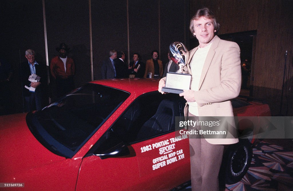 Joe Montana Holds Trophy