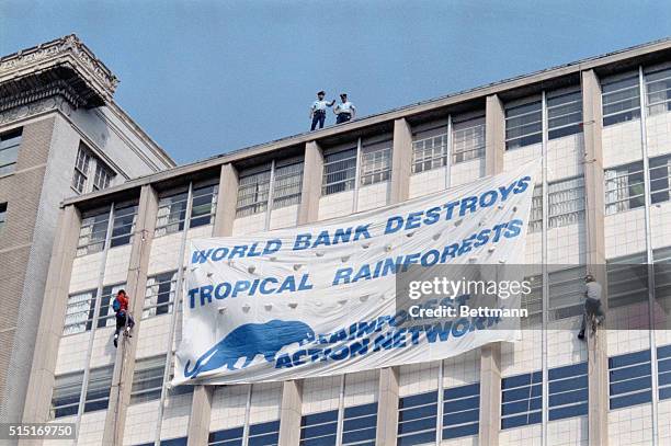 Washington: Policemen watch after two environmental activists scaled an 11-story building to display a giant protest banner across the street from...